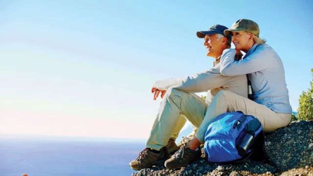 Couple sitting on mountainside relaxing after making STNL Property Investments